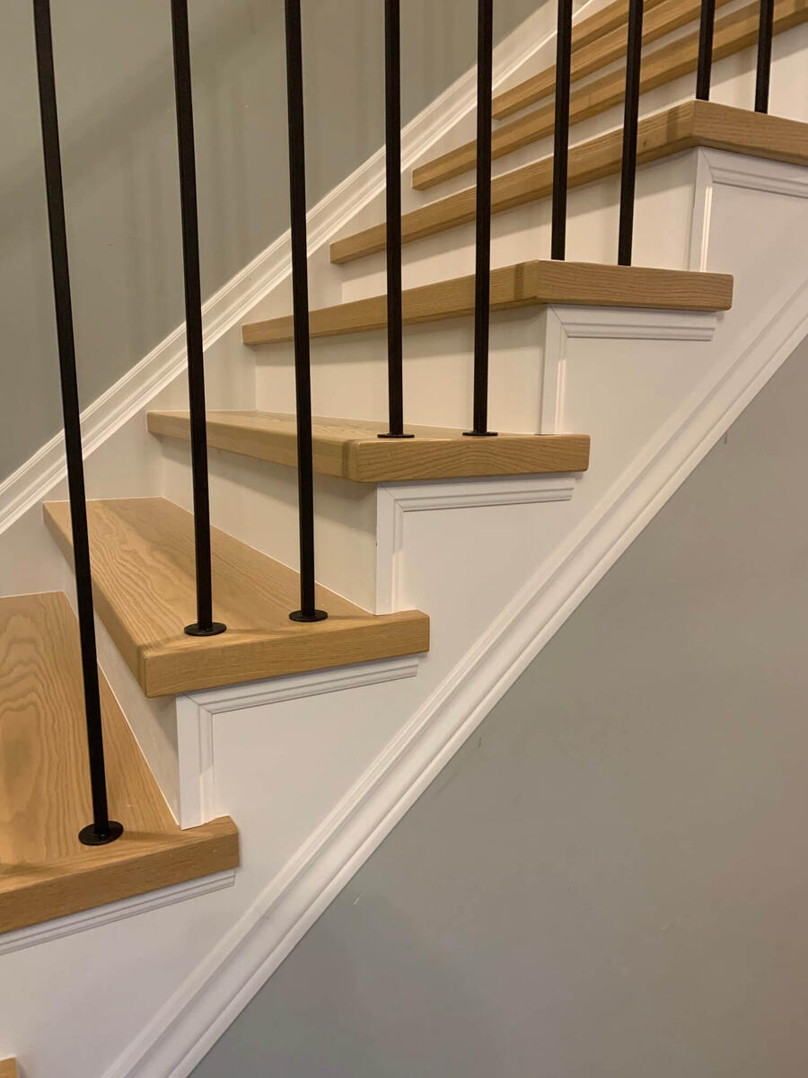 Staircase with custom wooden railings and steps