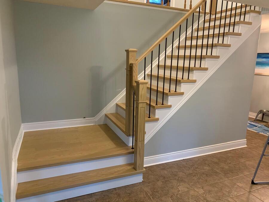 Modern staircase with polished wooden handrails