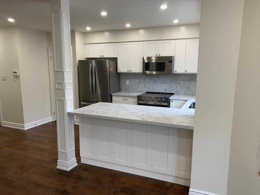 Finished kitchen renovation with modern cabinets, counters, and floors