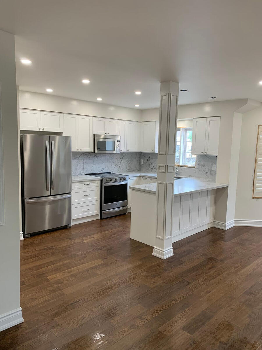 Finished kitchen renovation with modern cabinets, counters, and floors