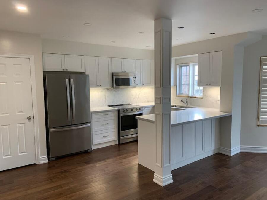 Finished kitchen renovation with modern cabinets, counters, and floors