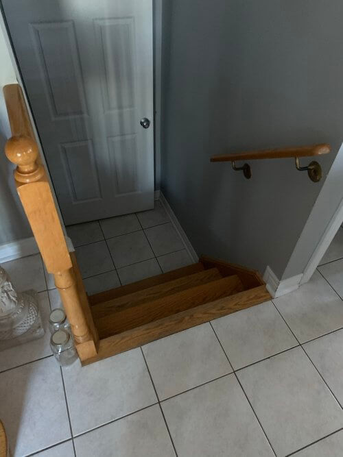 Before photo of tile flooring and staircase