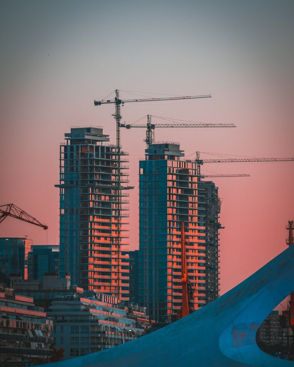 buildings under construction with cranes